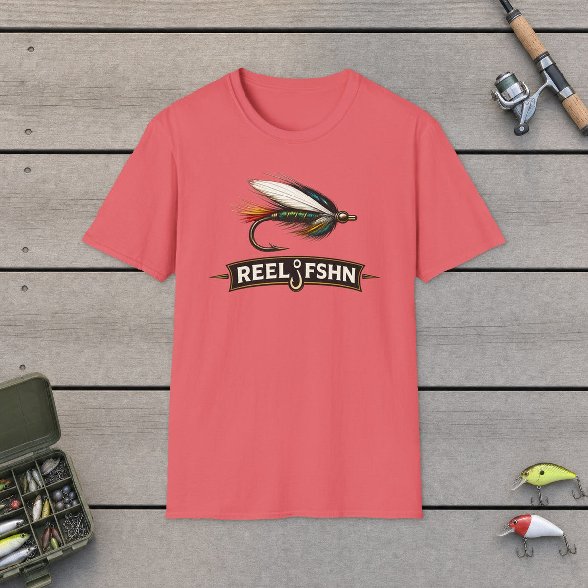 REEL FSHN FLY LURE T-Shirt on a wooden dock with fishing rod, reel, tackle box and lures