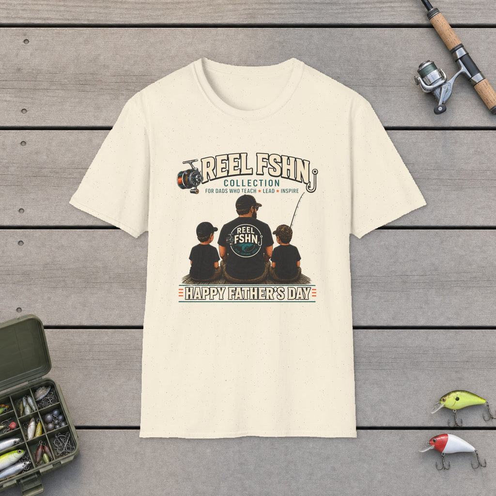 REEL FSHN Happy Father's Day T-Shirt flat-laid on wooden dock boards beside a fishing rod and tackle box