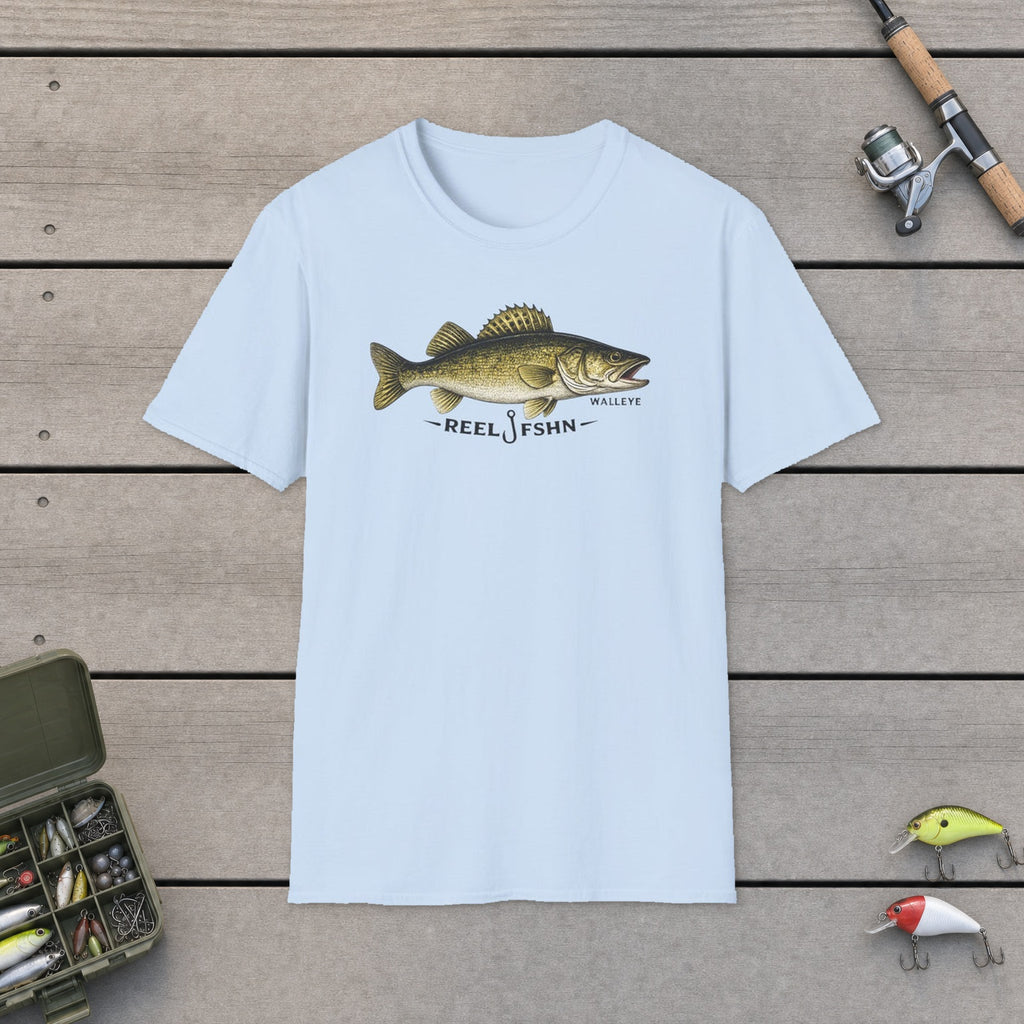 REEL FSHN WALLEYE T-Shirt flat-laid on wooden dock boards beside a fishing rod and tackle box