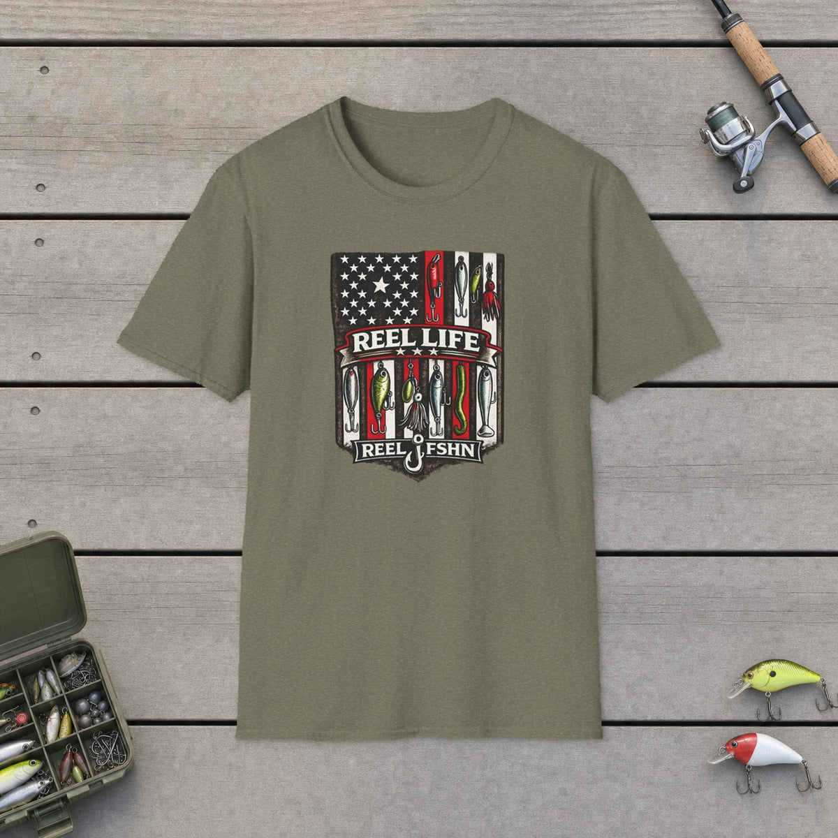 REEL Life! T-Shirt on a wooden dock with fishing rod, reel, tackle box and lures
