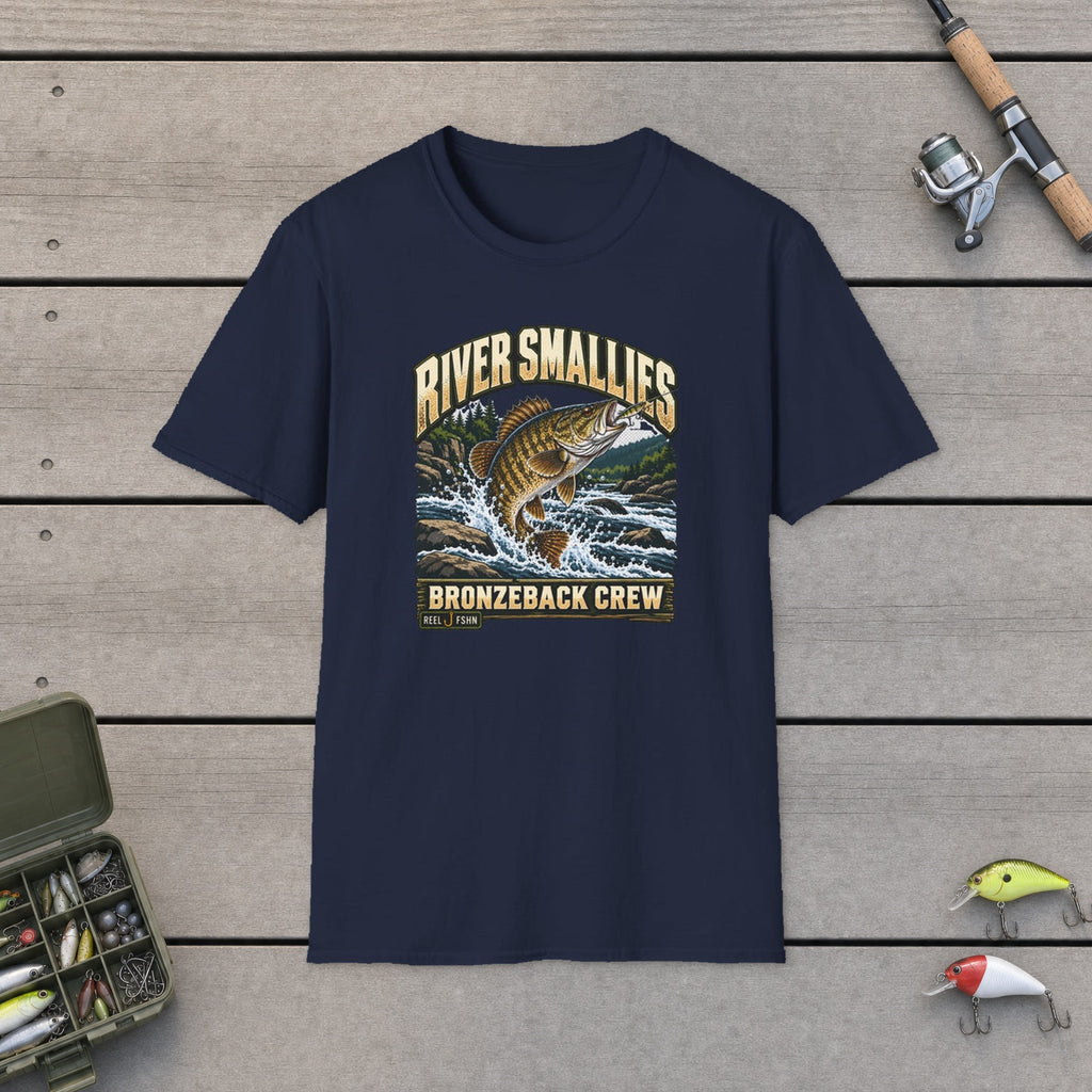 River Smallies T-Shirt flat-laid on wooden dock boards beside a fishing rod and tackle box