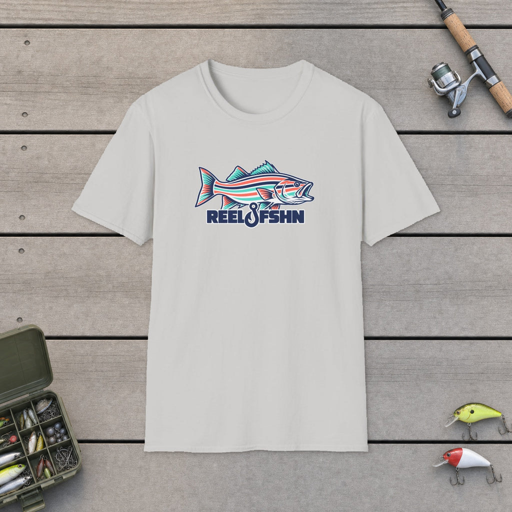 Striped Seafoam Bass T-Shirt flat-laid on wooden dock boards beside a fishing rod and tackle box