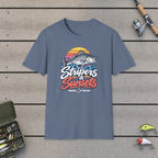 Stripers & Sunsets T-Shirt on a wooden dock with fishing rod, reel, tackle box and lures