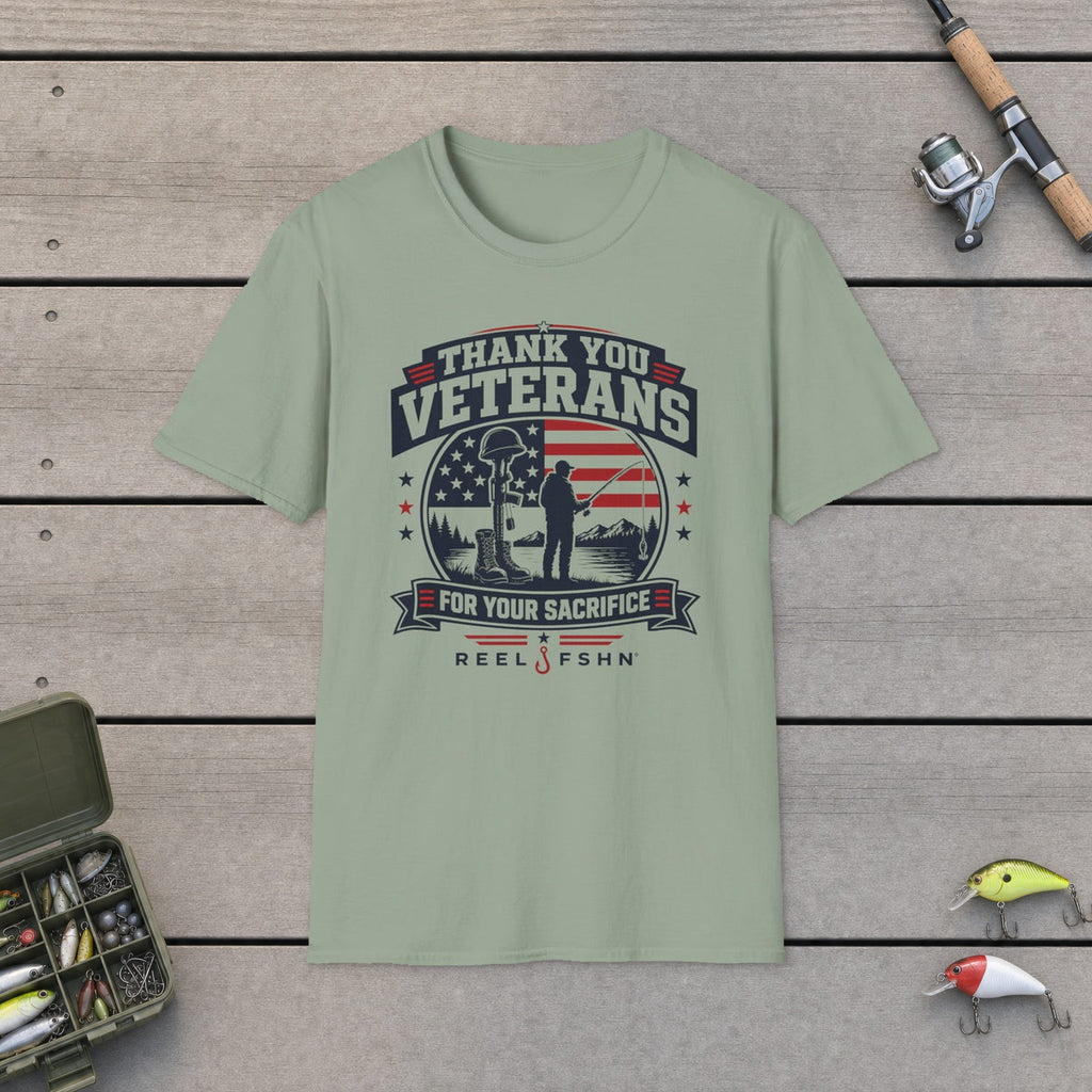 Thank You Veterans For Your Sacrifice T-Shirt flat-laid on wooden dock boards beside a fishing rod and tackle box