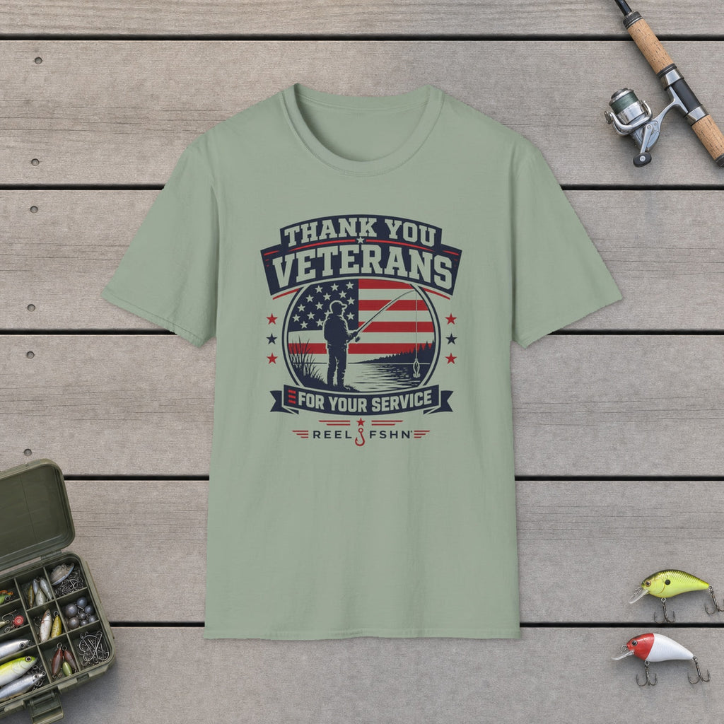 Thank You Veterans For Your Service T-Shirt flat-laid on wooden dock boards beside a fishing rod and tackle box