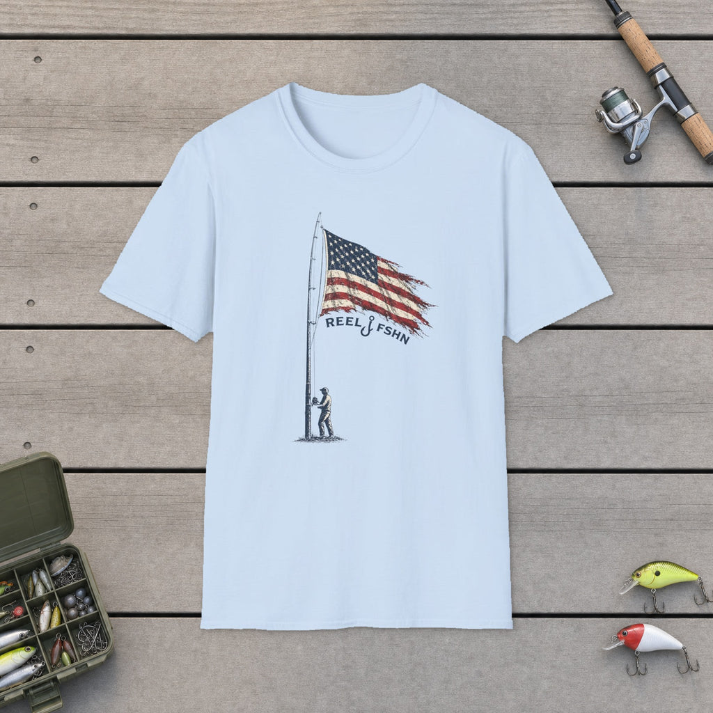 Vintage American Flag T-Shirt flat-laid on wooden dock boards beside a fishing rod and tackle box