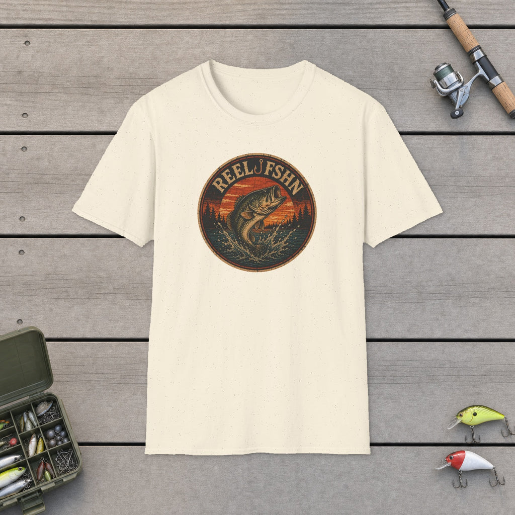 Vintage Bass Badge T-Shirt flat-laid on wooden dock boards beside a fishing rod and tackle box
