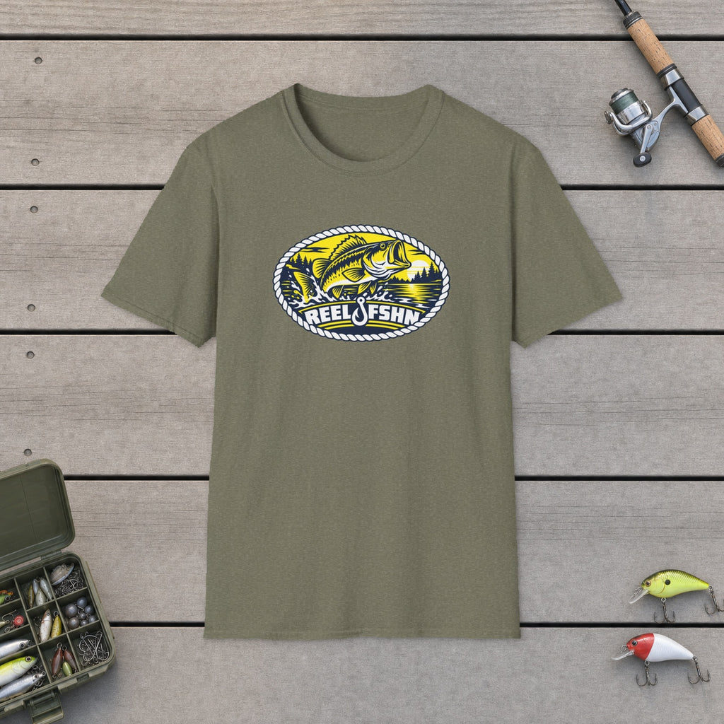 Yellow Bass Badge T-Shirt flat-laid on wooden dock boards beside a fishing rod and tackle box