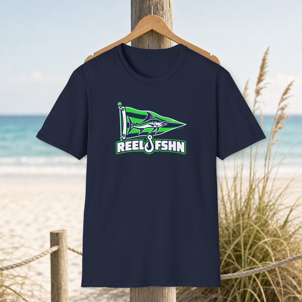 Green Marlin Pennant Flag T-Shirt on a hanger beside a sandy beach and turquoise coastal water