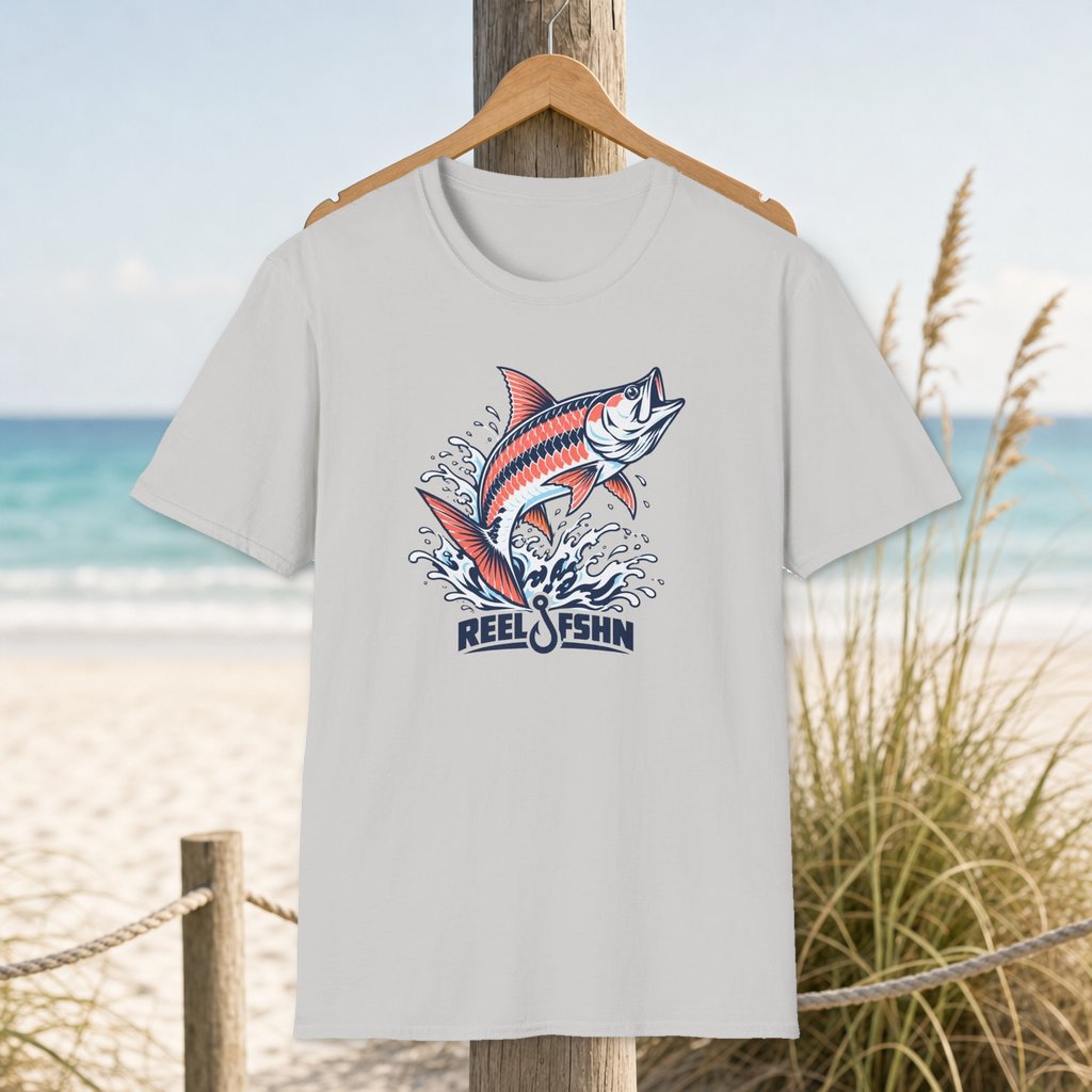 Jumping Tarpin T-Shirt on a hanger beside a sandy beach and turquoise coastal water