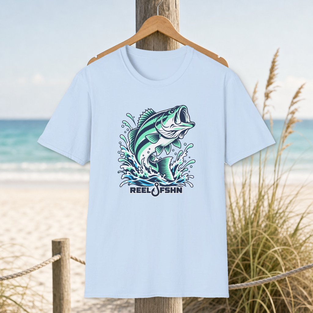 Leaping Largemouth T-Shirt on a hanger beside a sandy beach and turquoise coastal water