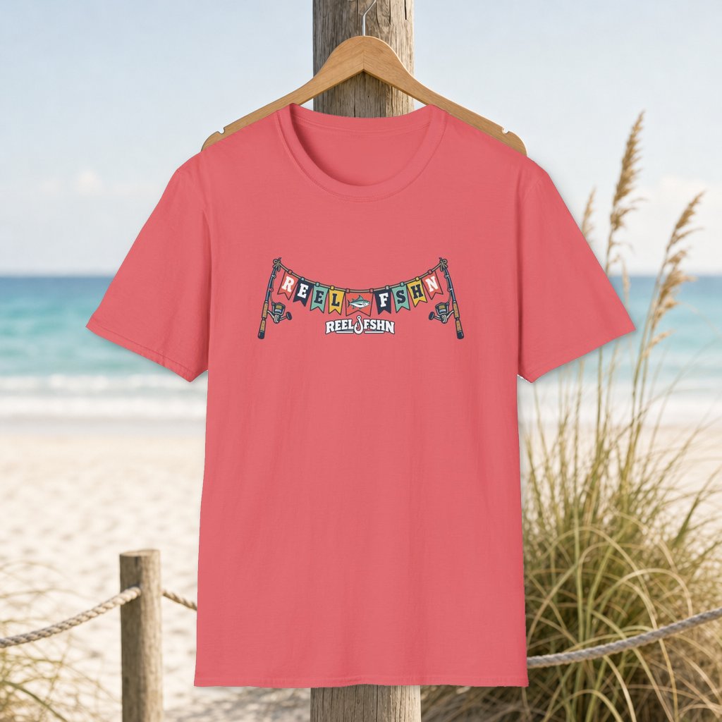 Pennant REEL FSHN Garland T-Shirt on a hanger beside a sandy beach and turquoise coastal water