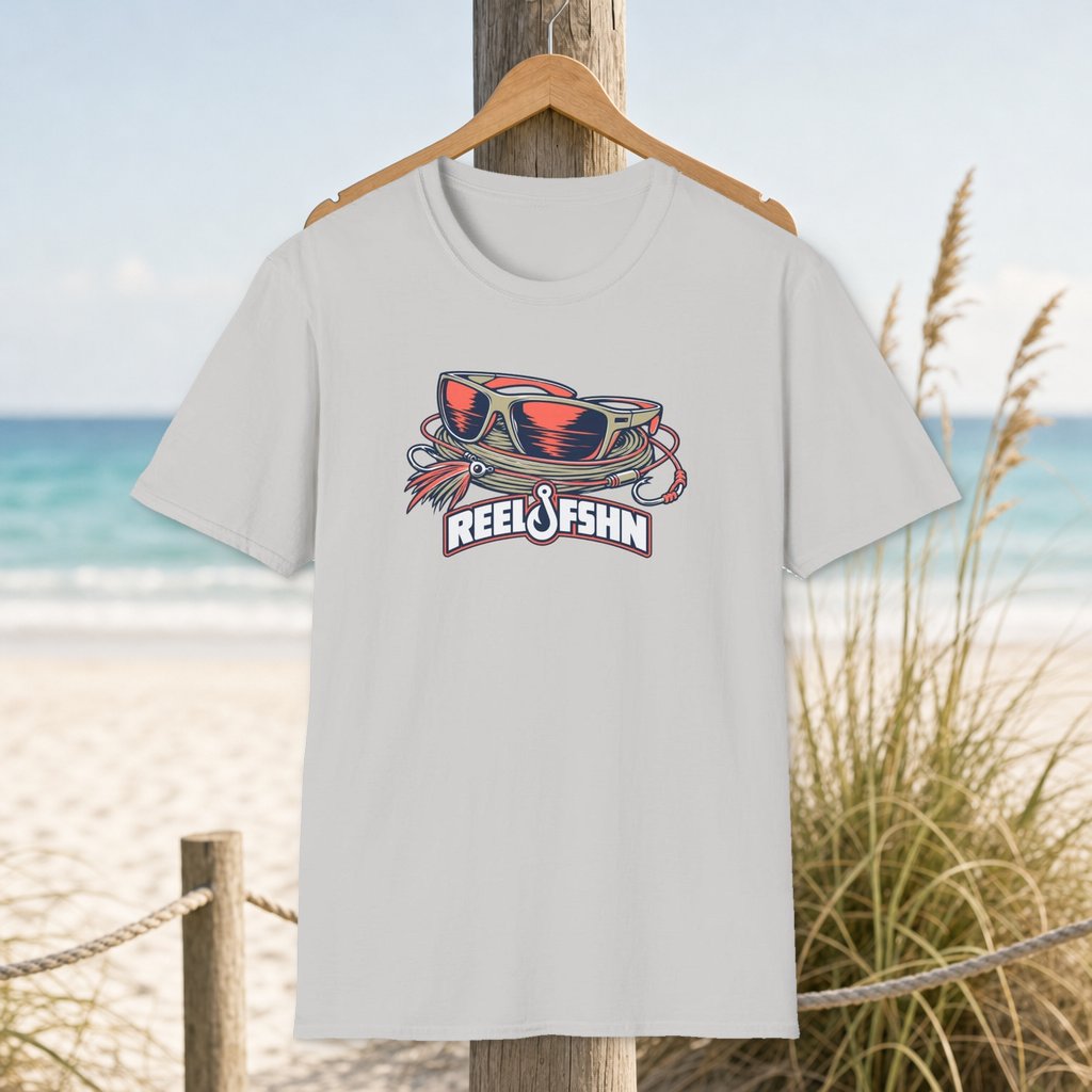 Polarized Sunglasses T-Shirt on a hanger beside a sandy beach and turquoise coastal water