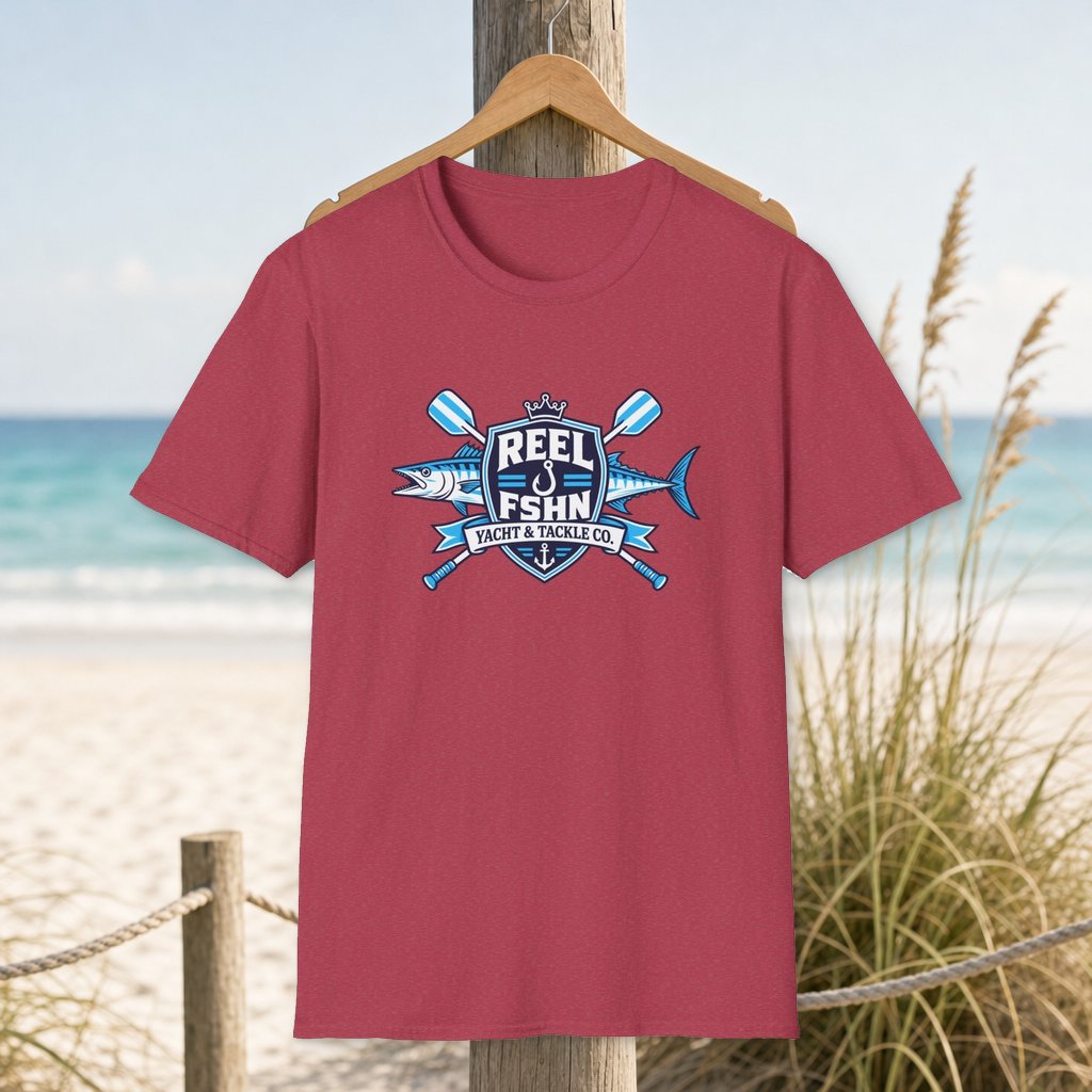 Yacht & Tackle Co. T-Shirt on a hanger beside a sandy beach and turquoise coastal water